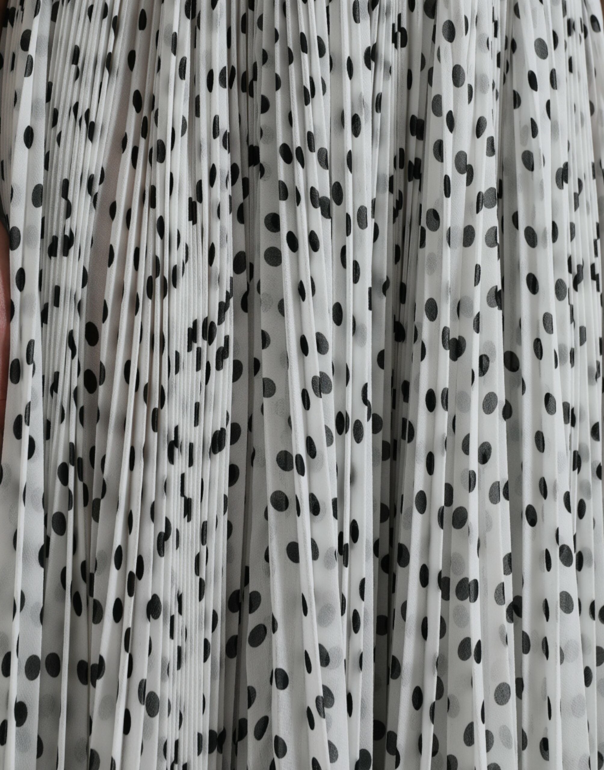 White polka dot A-line pleated maxi dress by Dolce & Gabbana, featuring a flowing silhouette and elegant design.