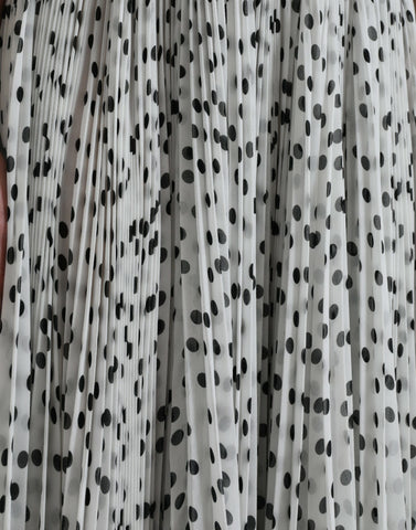 White polka dot A-line pleated maxi dress by Dolce & Gabbana, featuring a flowing silhouette and elegant design.