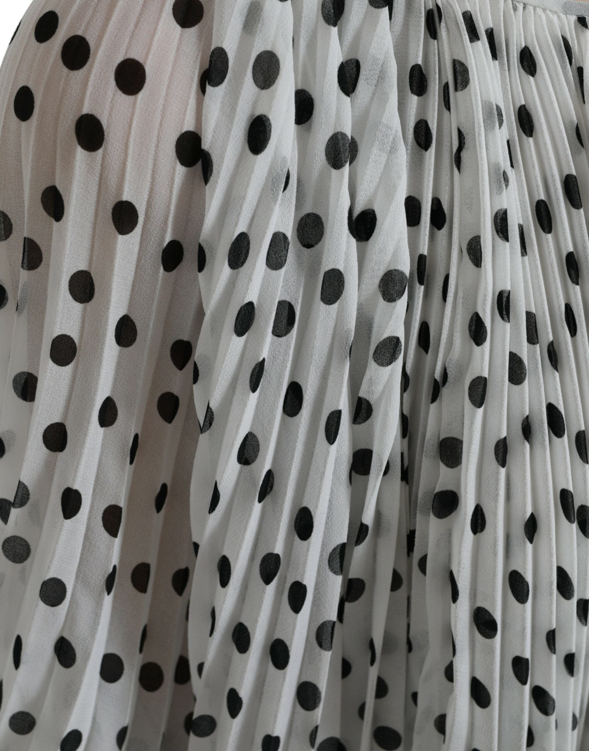 White polka dot A-line pleated maxi dress by Dolce & Gabbana, featuring a flowing silhouette and classic pattern.