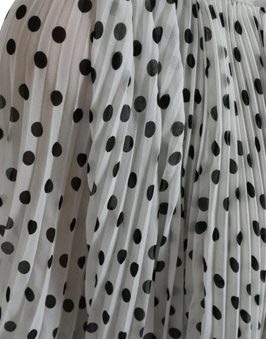 White polka dot A-line pleated maxi dress by Dolce & Gabbana, featuring a flowing silhouette and classic pattern.