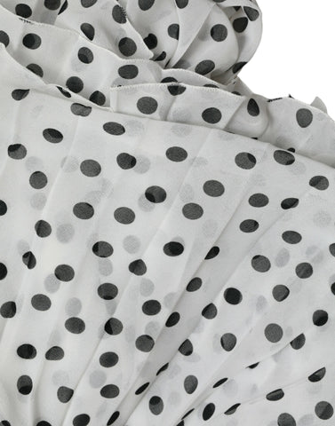 White polka dot A-line pleated maxi dress by Dolce & Gabbana, featuring a flowing silhouette and classic pattern.