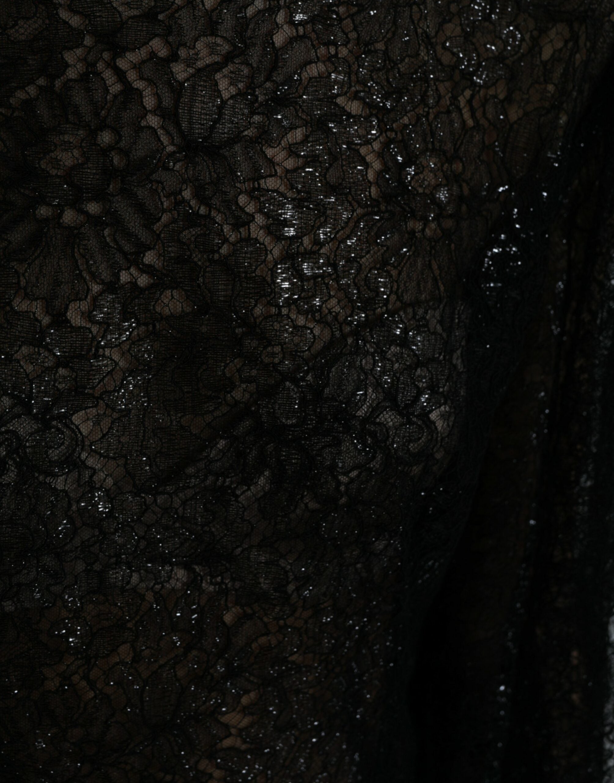 Black floral lace sheer A-line midi dress by Dolce & Gabbana, featuring intricate lace details and a flowing silhouette.
