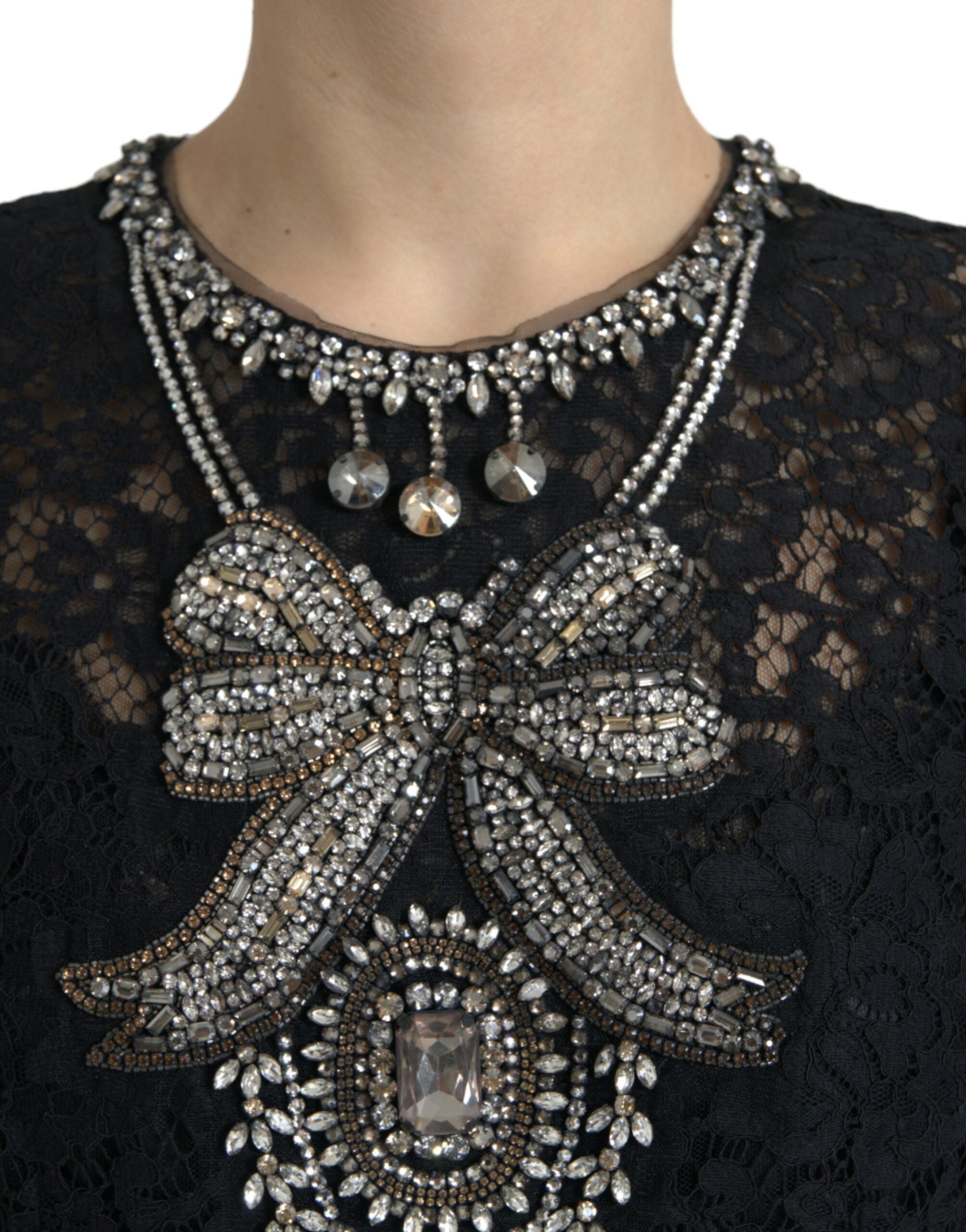 Black lace sheath dress with crystal embellishments by Dolce & Gabbana, featuring a fitted silhouette and intricate detailing.