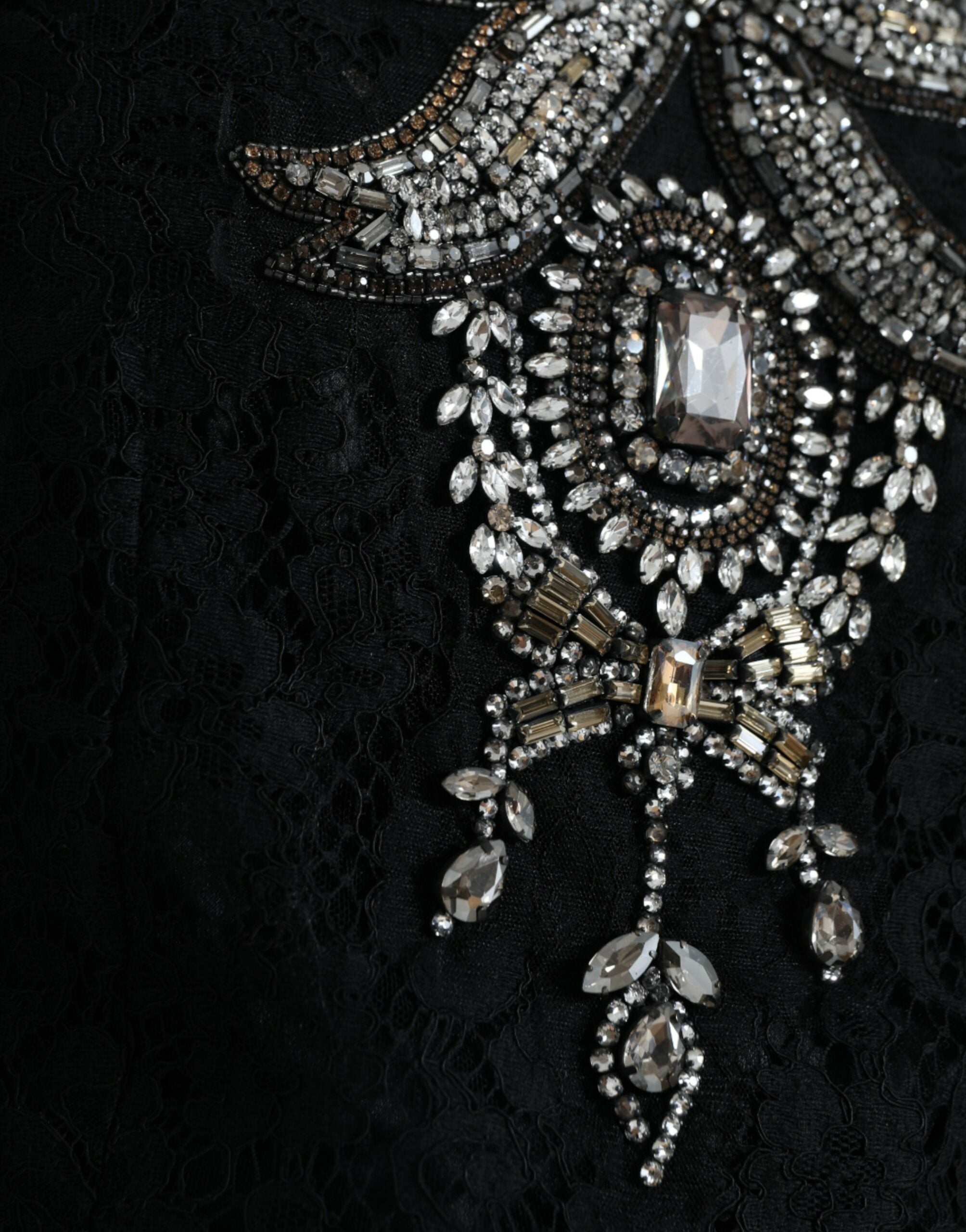 Black lace crystal-embellished sheath dress by Dolce & Gabbana, featuring intricate lace details and sparkling crystal accents.