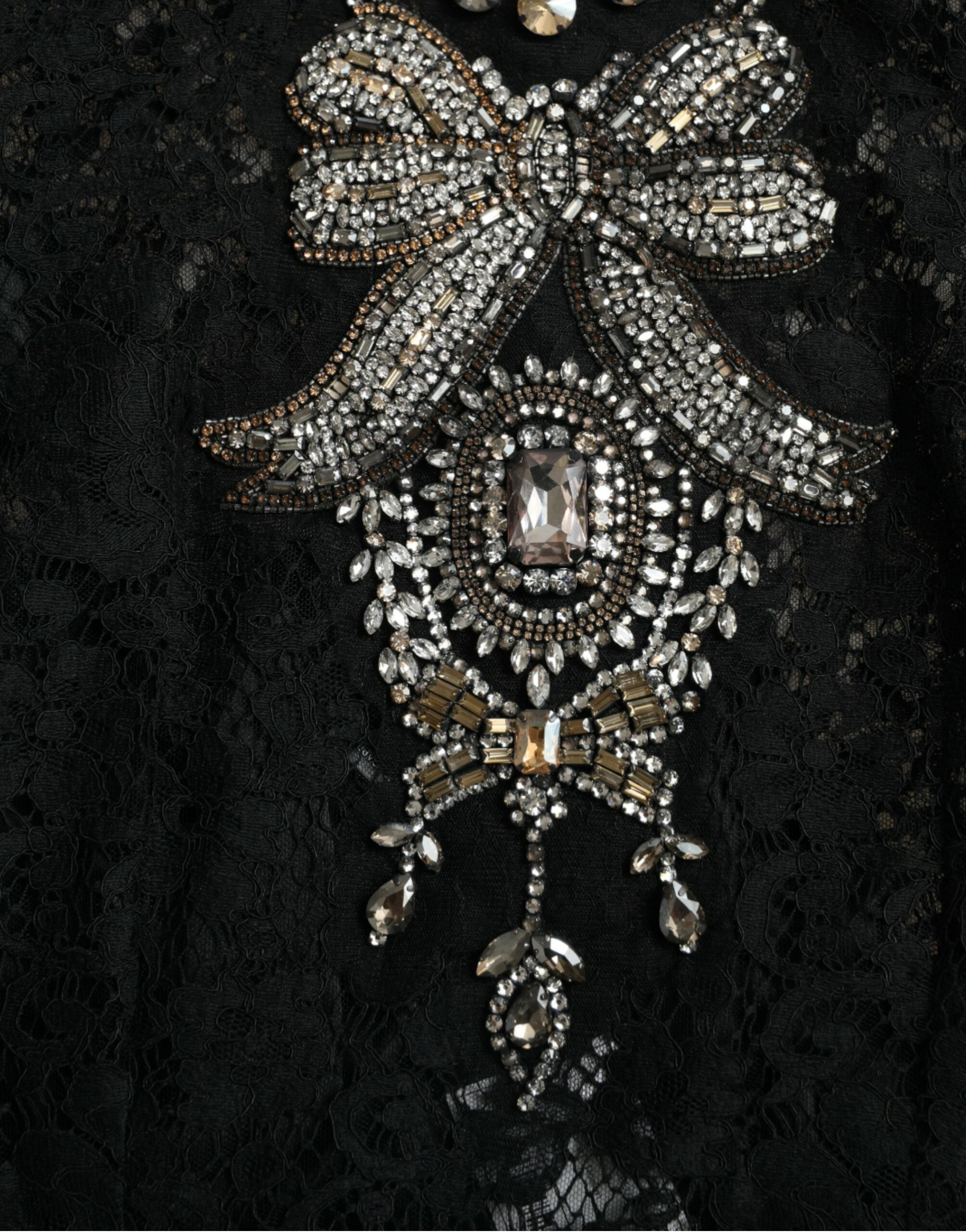 Black lace sheath dress with crystal embellishments by Dolce & Gabbana, featuring a fitted silhouette and intricate lace details.