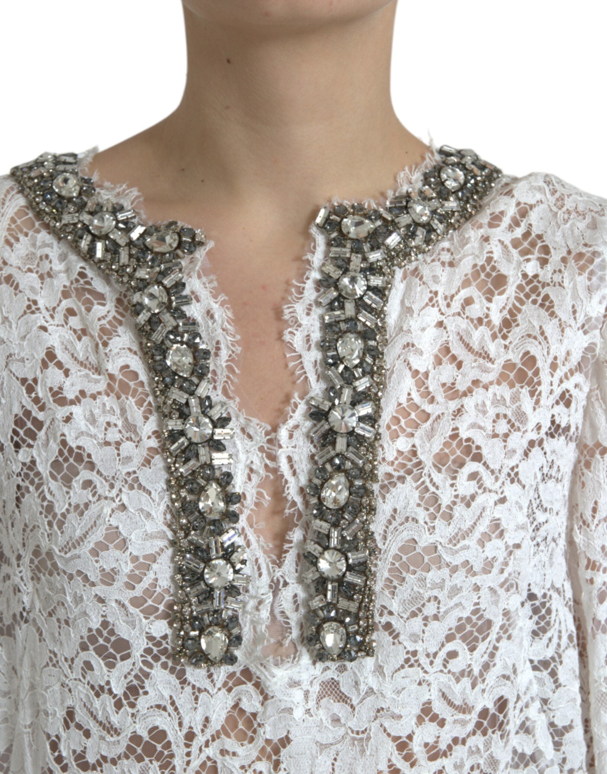 White lace shift dress with crystal embellishments by Dolce & Gabbana, featuring a elegant, sleeveless design and intricate lace details.