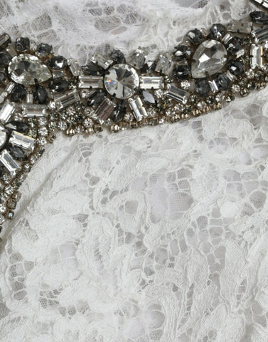White lace shift dress with crystal embellishments by Dolce & Gabbana, featuring elegant details and a sleek silhouette.