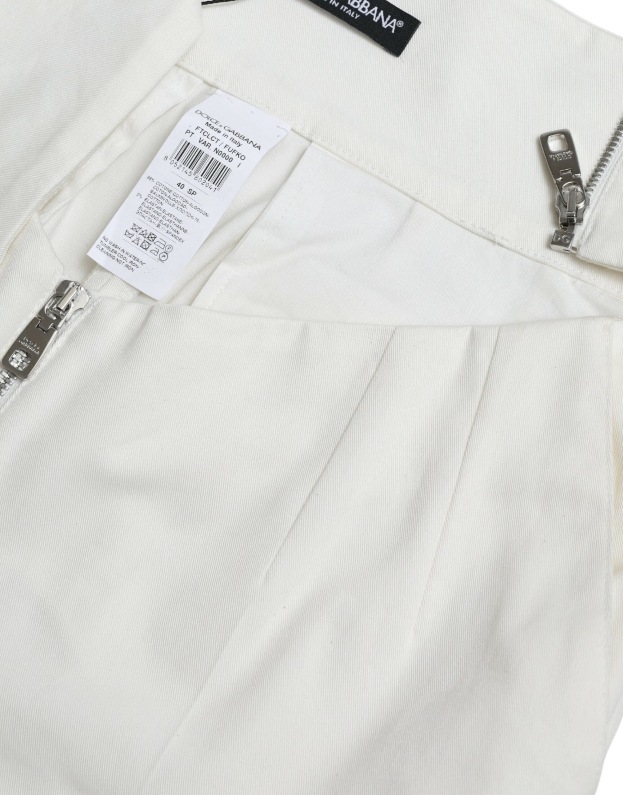 Black and white cotton tapered pants with cut-out waist from Dolce & Gabbana, featuring a stylish, modern design.