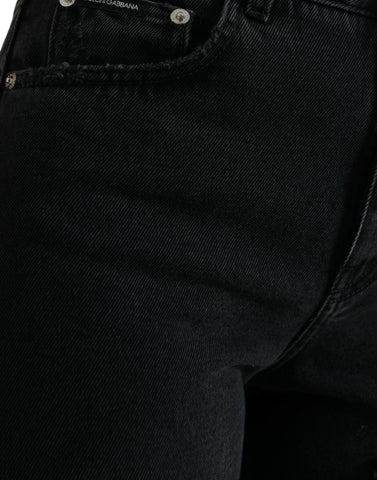 Black cotton high waist tattered denim jeans by Dolce & Gabbana, featuring distressed details and a slim fit silhouette.