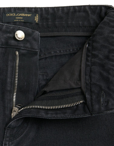 Black cotton high-waist tattered denim jeans by Dolce & Gabbana, showing distressed details and classic fit.