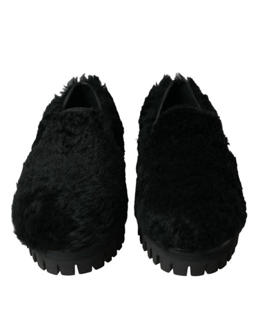 Black fur leather slippers dress shoes by Dolce & Gabbana with sleek design and luxurious texture.