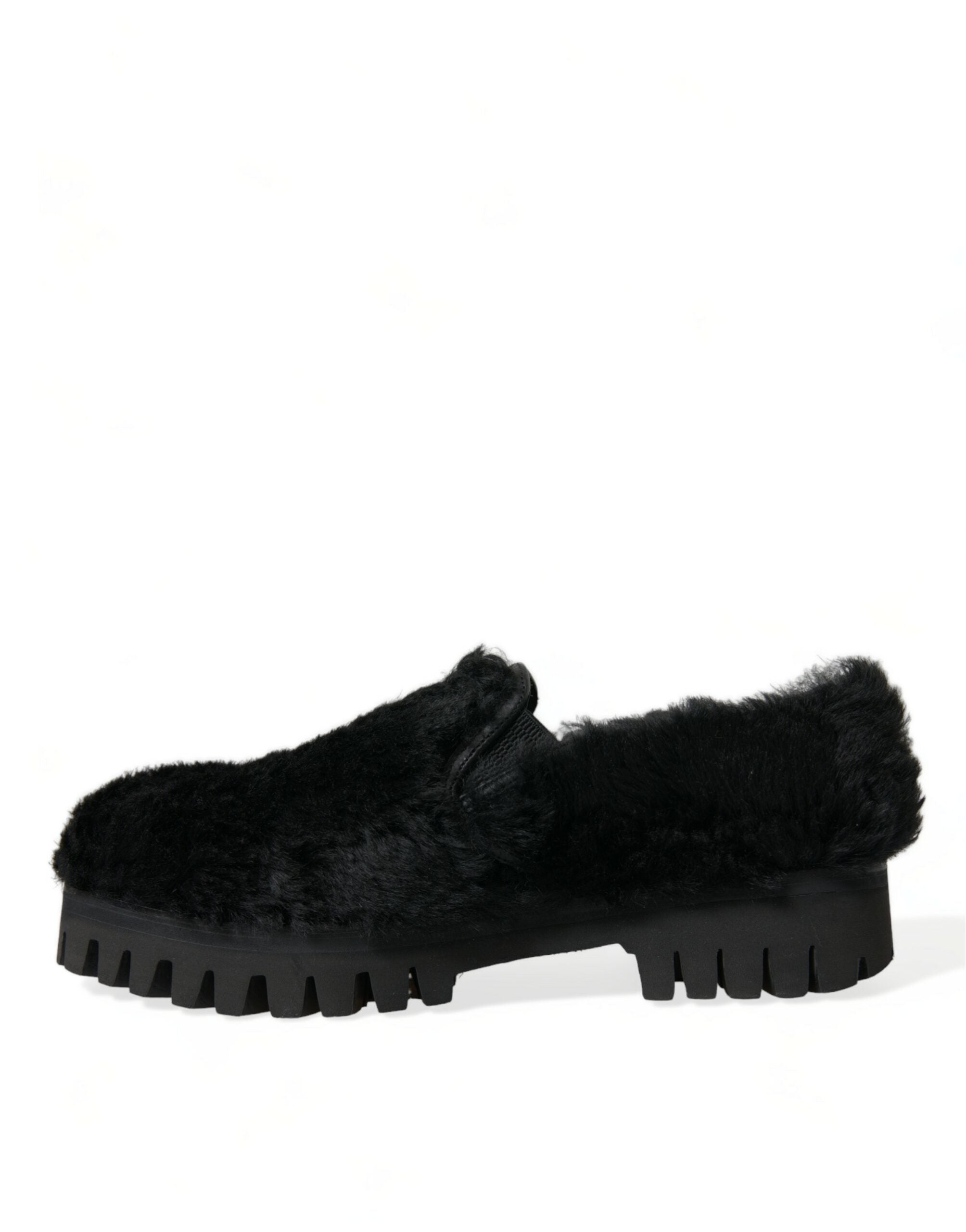Black fur leather slippers dress shoes by Dolce & Gabbana, featuring a sleek design with luxurious fur accents and smooth leather finish.