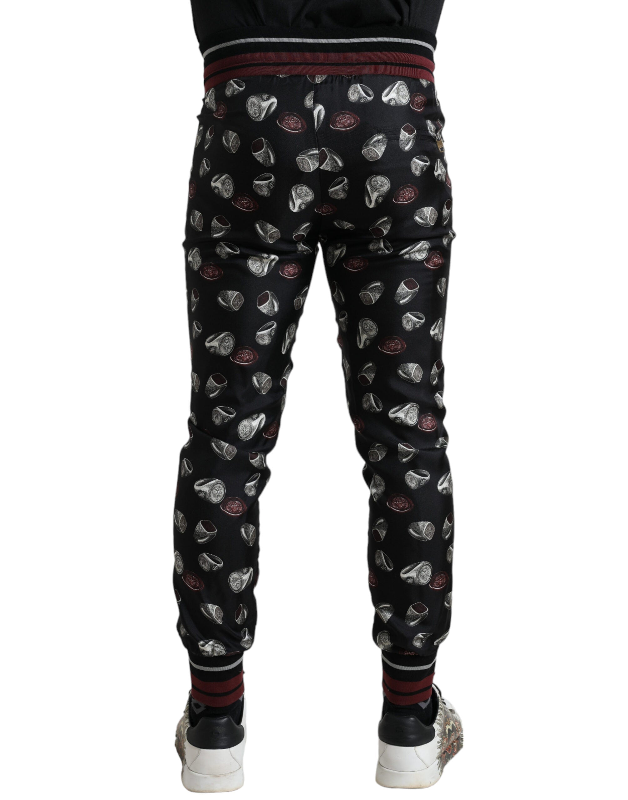 Black silk jogging trousers by Dolce & Gabbana featuring a relaxed fit and drawstring waistband, shown in the product image.