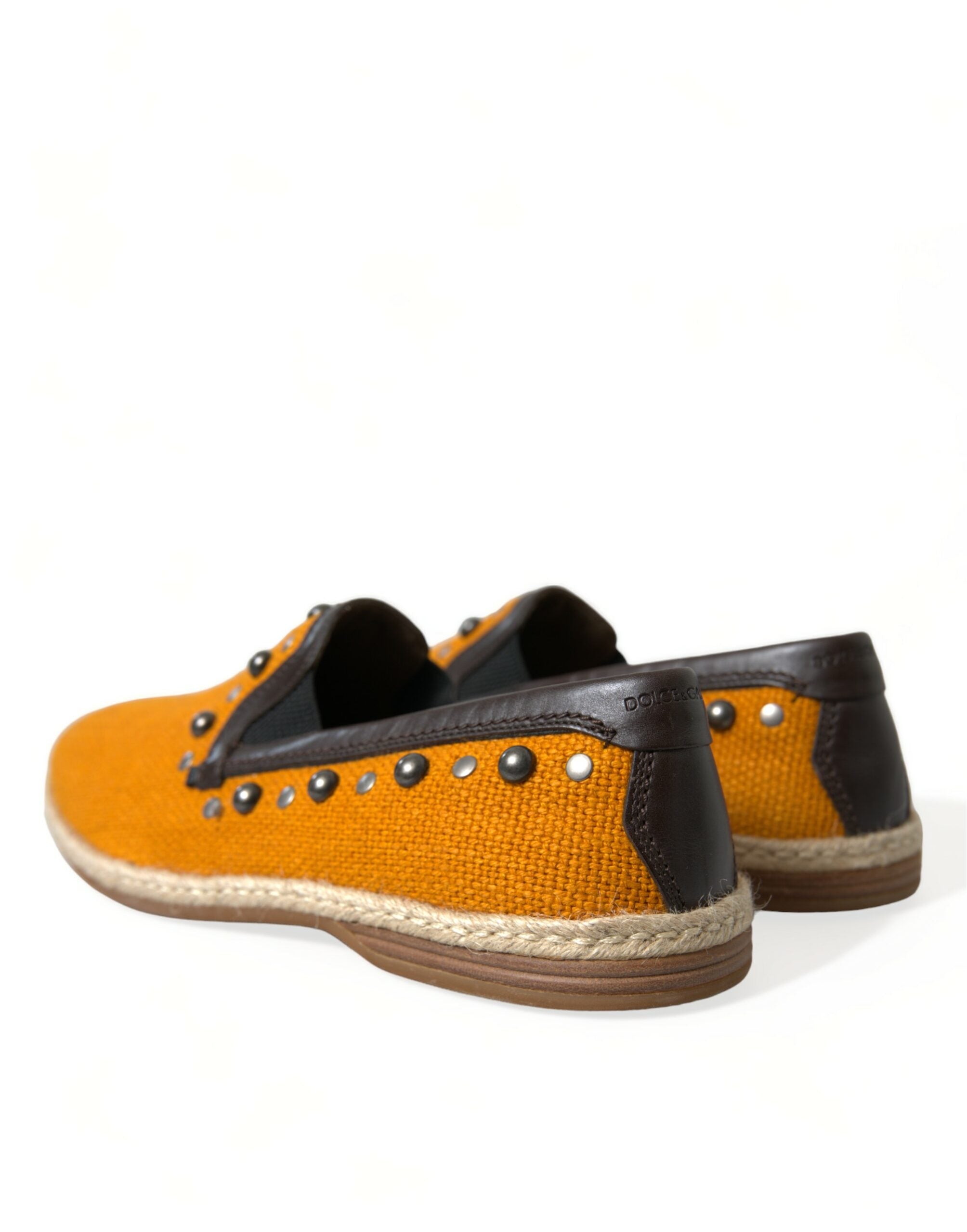 Orange linen leather studded loafers shoes by Dolce & Gabbana with metal stud details and a slip-on design.