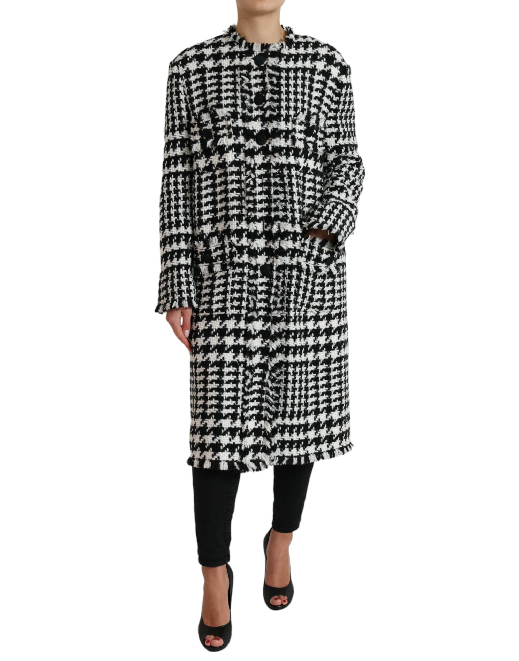 Black and white houndstooth trench coat jacket by Dolce & Gabbana, featuring classic double-breasted design and belted waist.