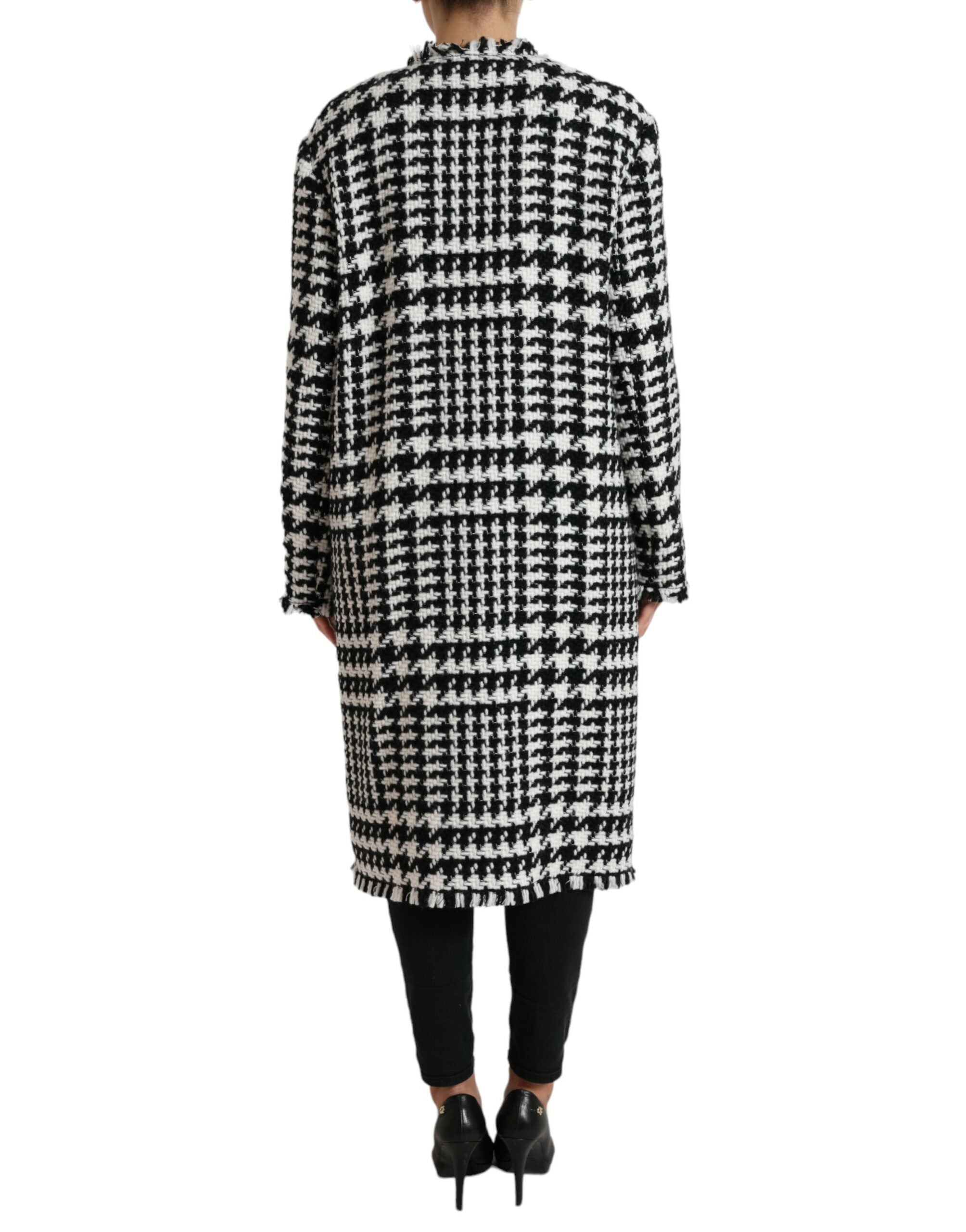 Dolce & Gabbana black and white houndstooth trench coat jacket displayed on a hanger, showcasing classic design and tailored fit.