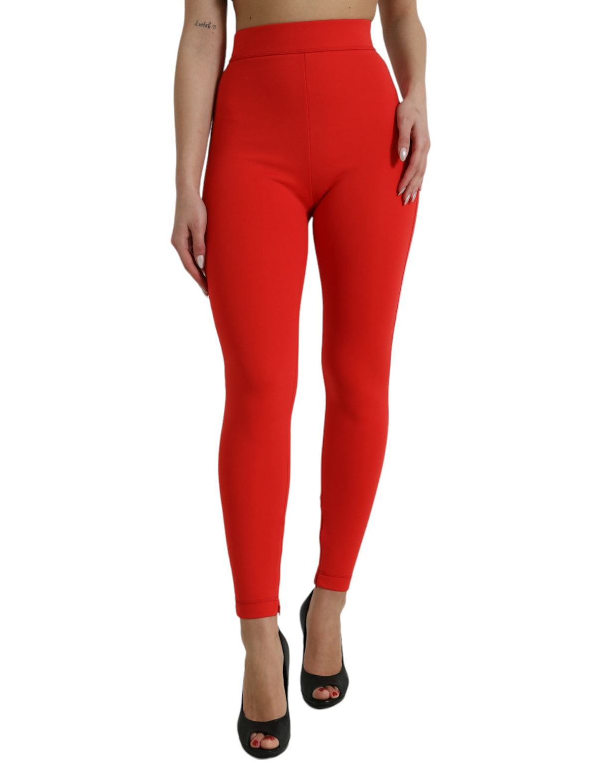 Red nylon stretch slim leggings by Dolce & Gabbana, close-up of fitted, high-waisted pants showing smooth fabric and sleek design.