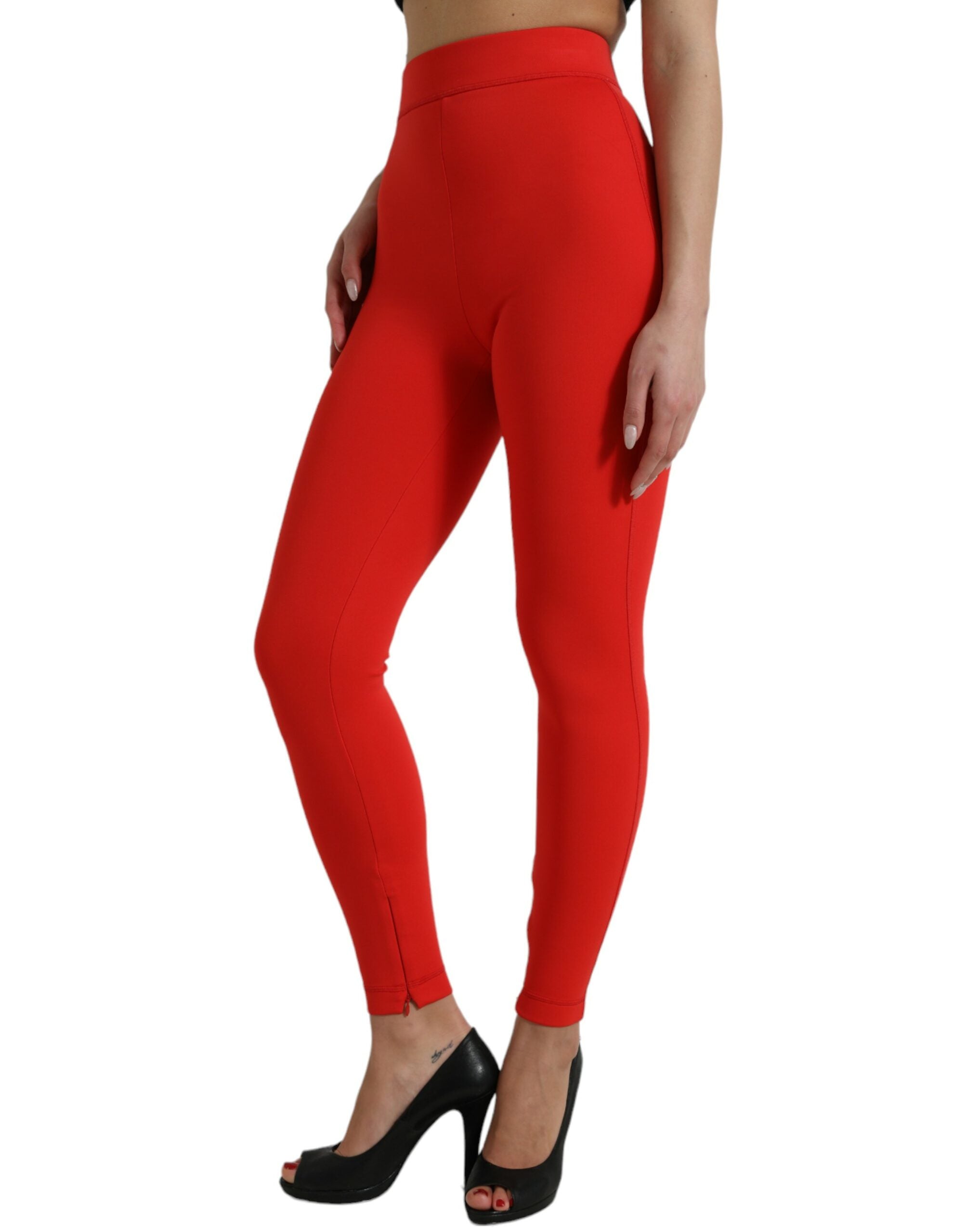 Red nylon stretch slim leggings pants by Dolce & Gabbana, close-up view showing fitted design and smooth fabric texture.