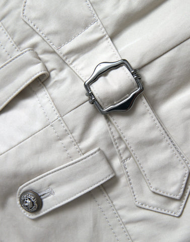 Beige cotton high waist tapered pants by Dolce & Gabbana, showing the relaxed fit and tailored design on a model.