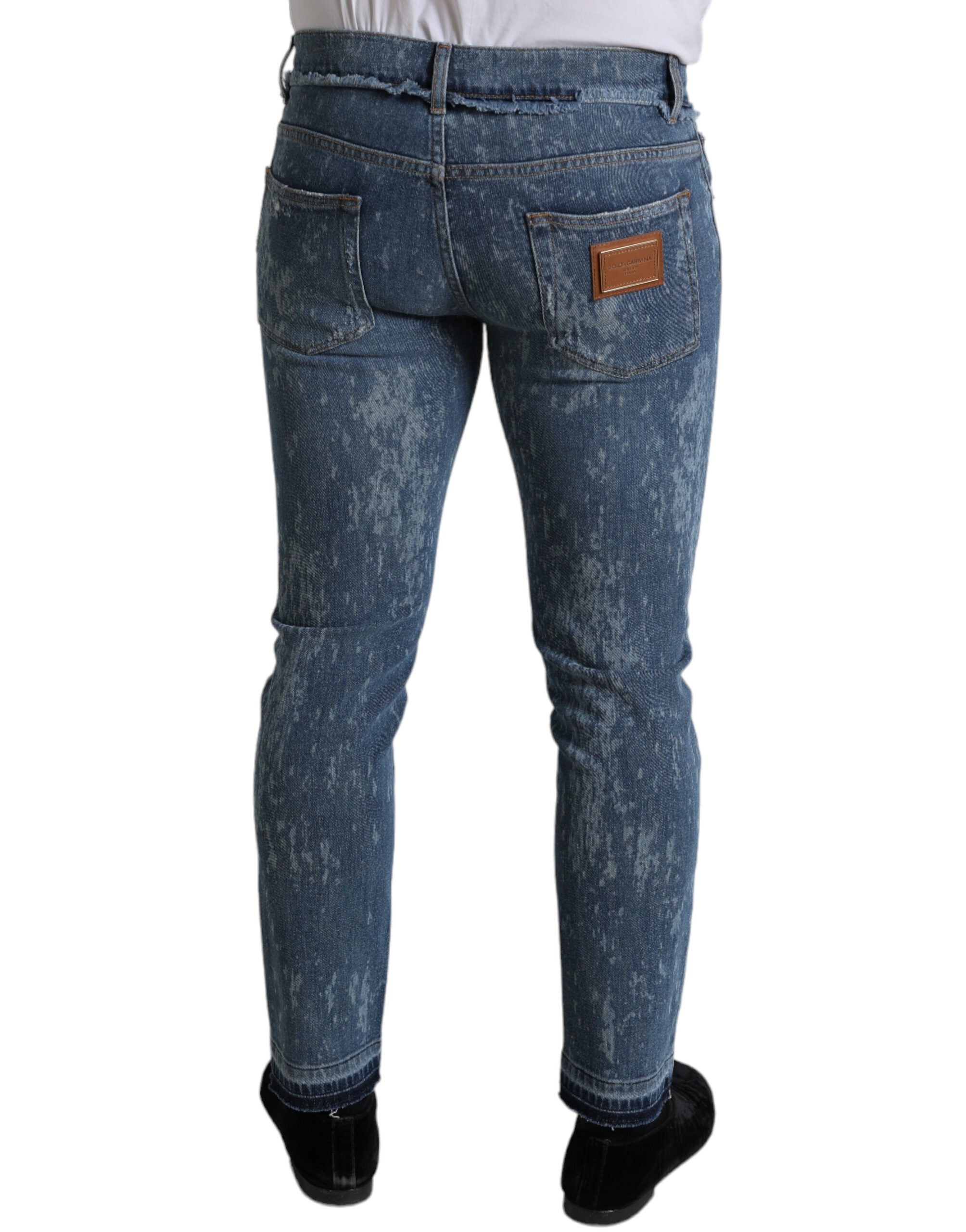 Blue washed skinny cotton stretch denim jeans by Dolce & Gabbana, close-up of fitted denim fabric and design details.