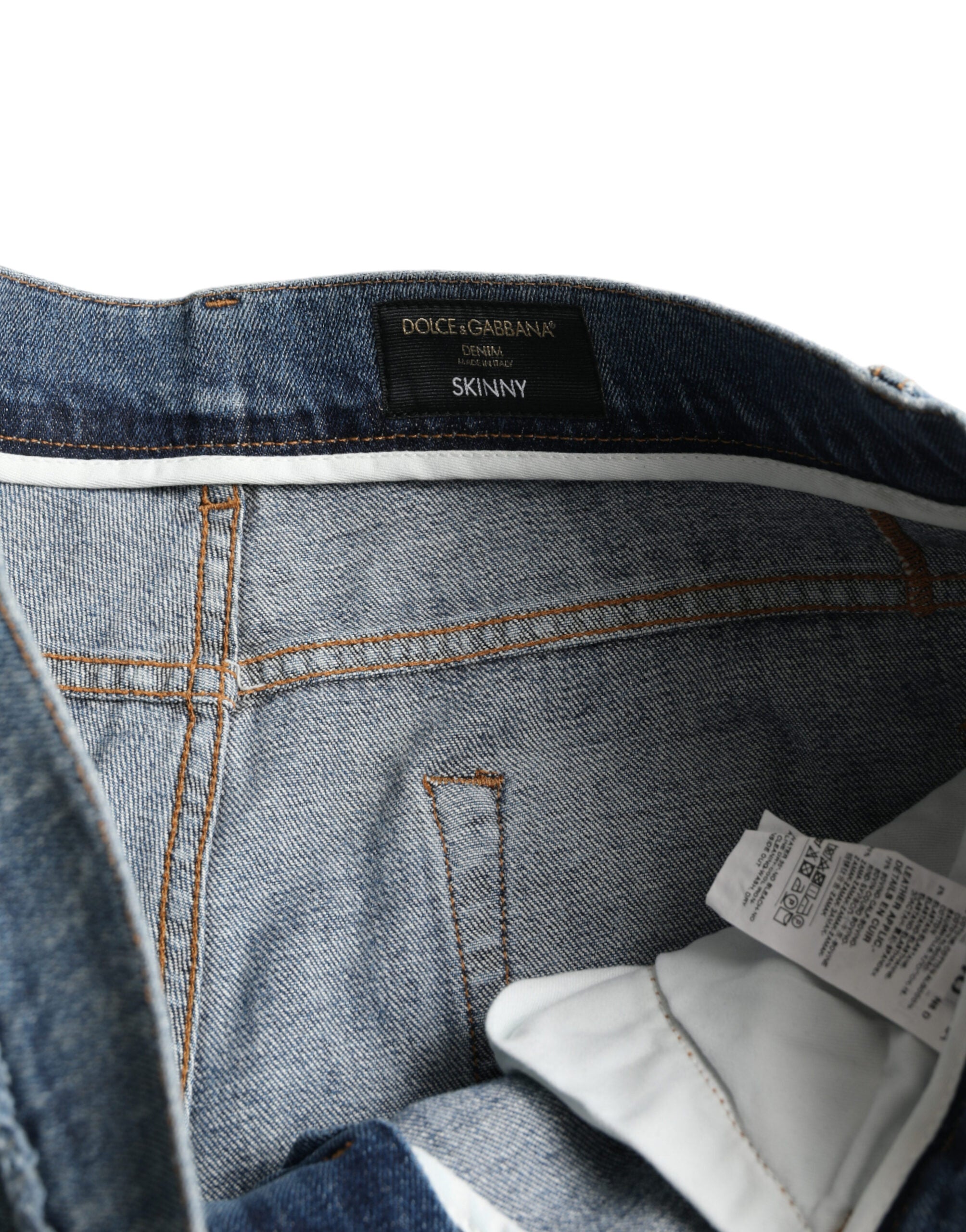 Blue washed skinny cotton stretch denim jeans by Dolce & Gabbana displayed on a hanger