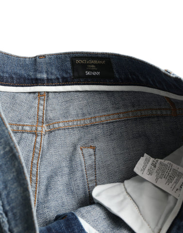 Blue washed skinny cotton stretch denim jeans by Dolce & Gabbana displayed on a hanger