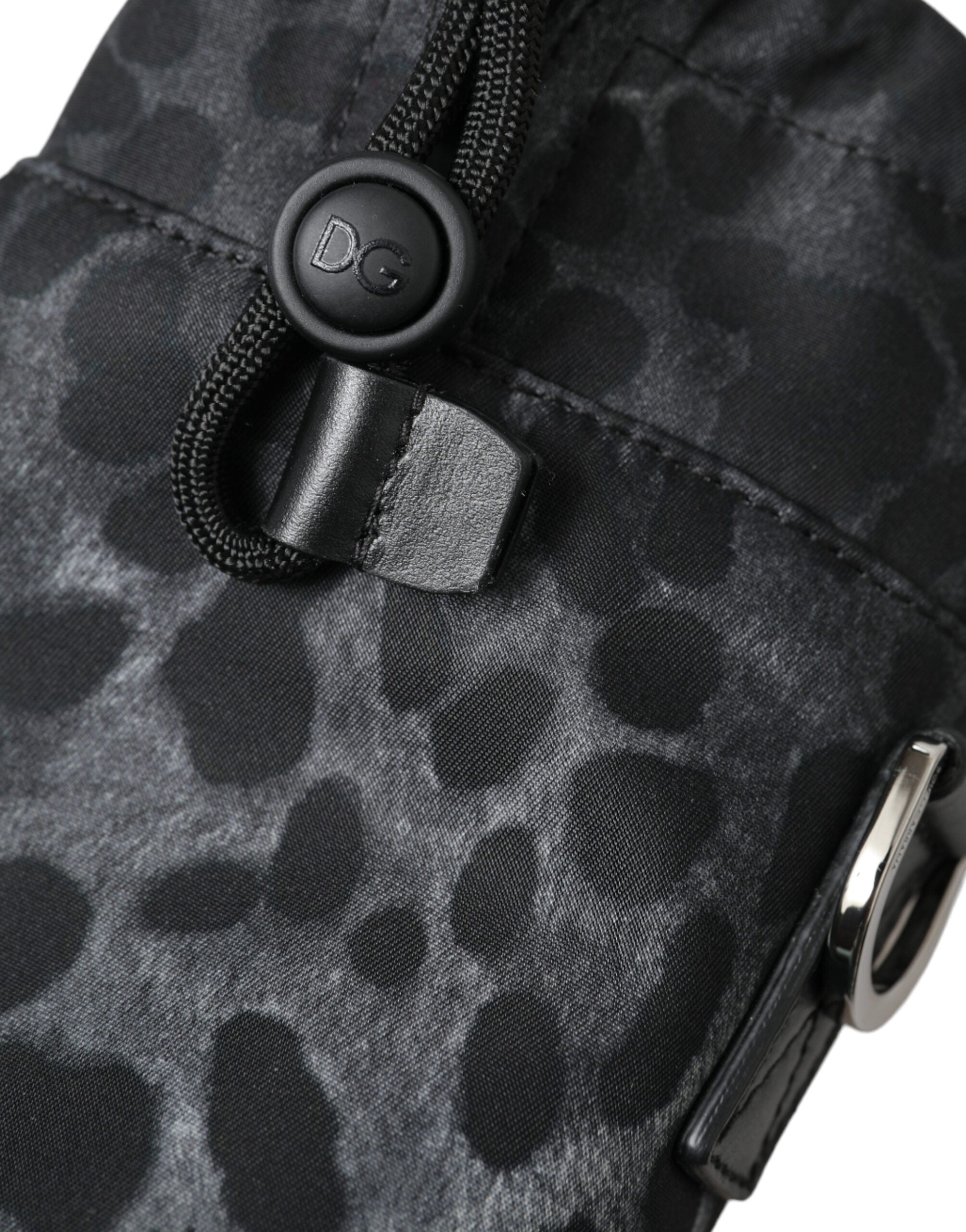Black leopard print round slim tote bottle cage bag by Dolce & Gabbana, featuring a compact cylindrical design with a top handle.