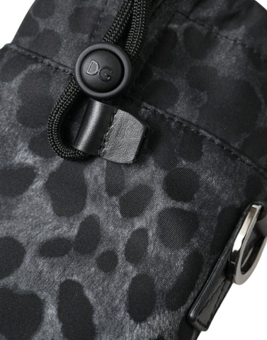 Black leopard print round slim tote bottle cage bag by Dolce & Gabbana, featuring a compact cylindrical design with a top handle.