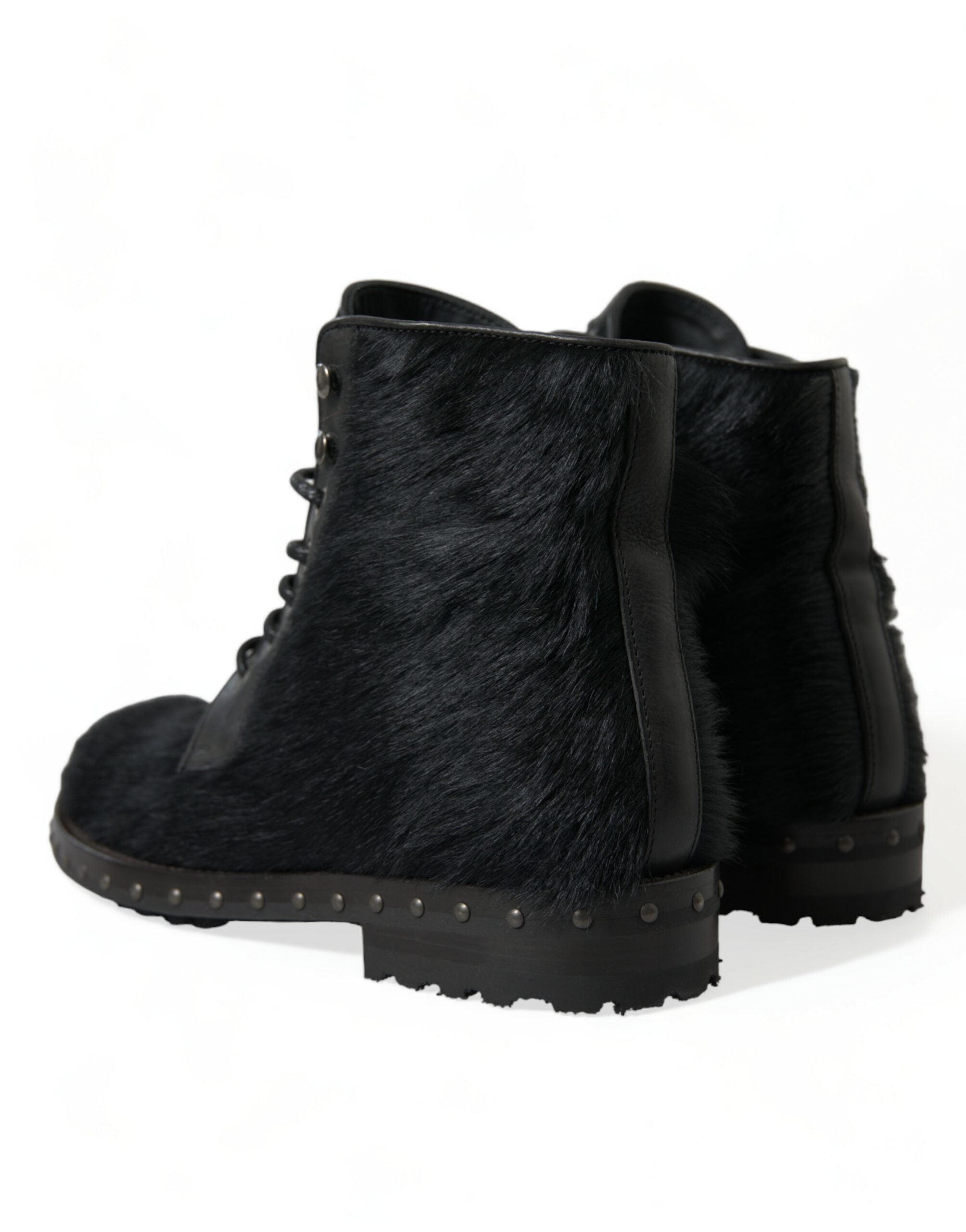 Black Dolce & Gabbana pony style leather mid-calf boots with pointed toes and block heels, shown from the side.