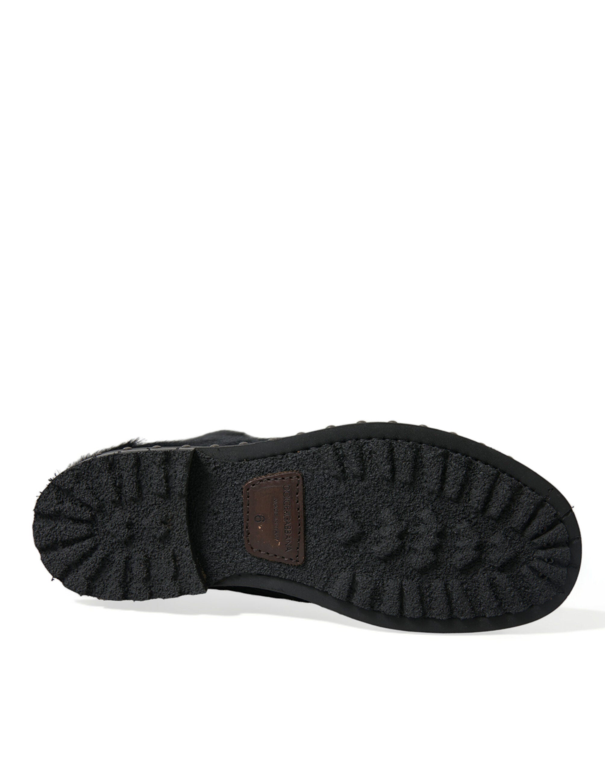 Black pony style leather mid-calf boots by Dolce & Gabbana, featuring sleek design and classic knee-high silhouette.