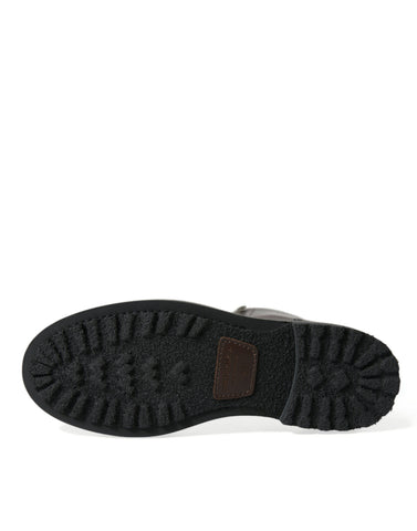 Black leather military combat boots by Dolce & Gabbana with sturdy soles and lace-up design.