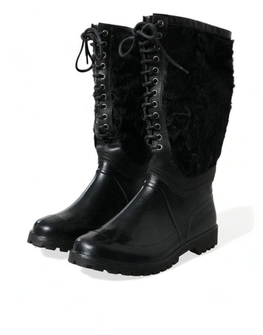 Black rubber lace-up shearling rain boots by Dolce & Gabbana with rugged soles and cozy shearling lining.