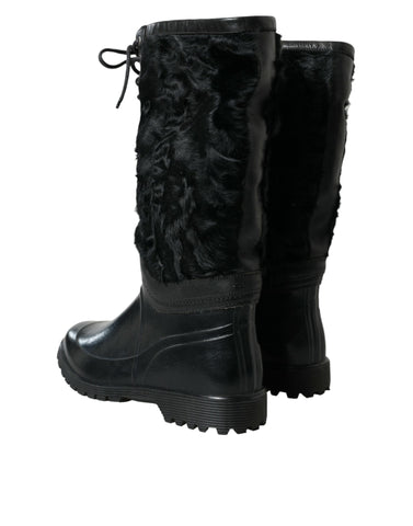 Black rubber lace-up shearling rain boots by Dolce & Gabbana with rugged soles and cozy shearling lining.