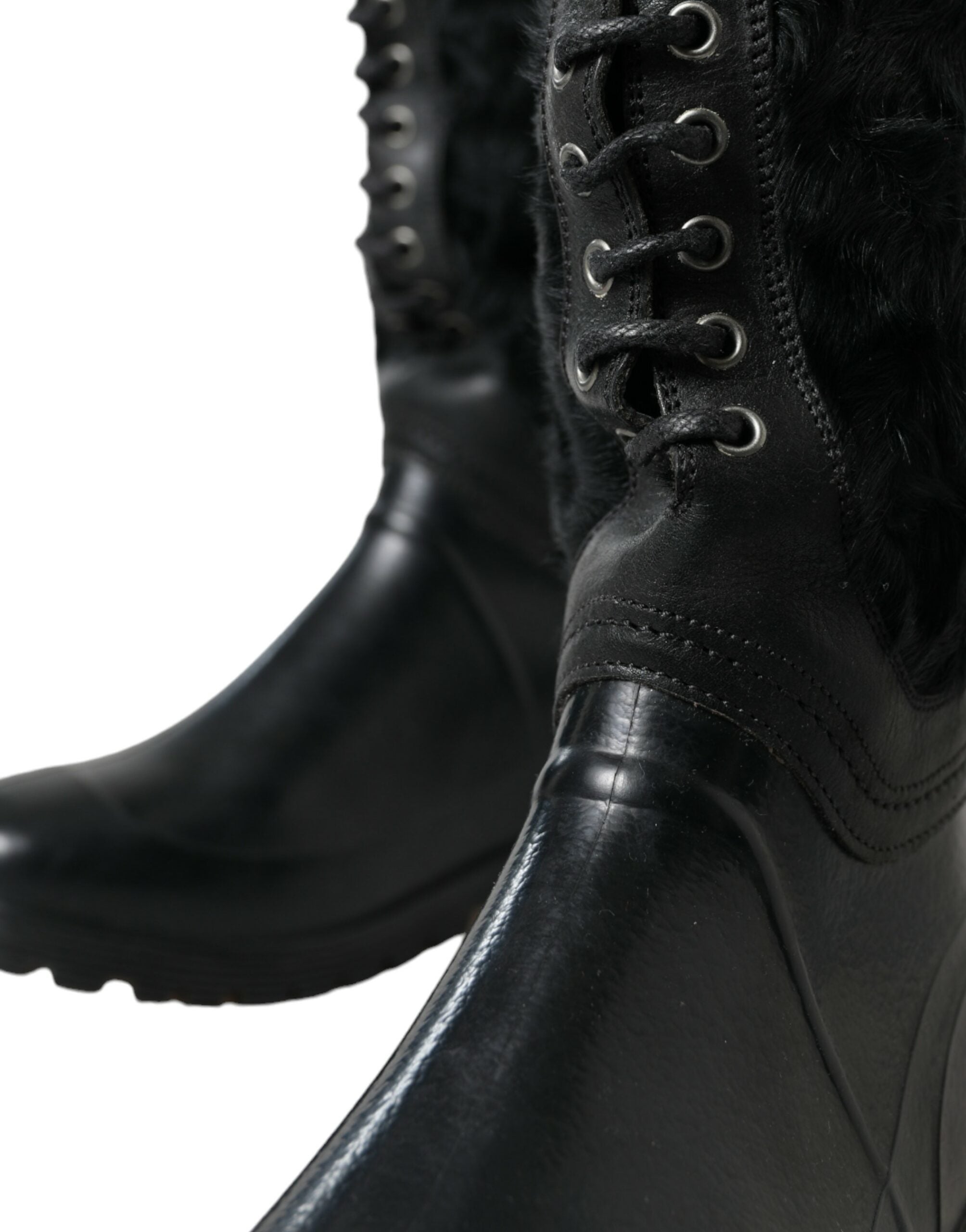 Black rubber shearling rain boots with lace-up design by Dolce & Gabbana, featuring sturdy soles and cozy shearling lining.
