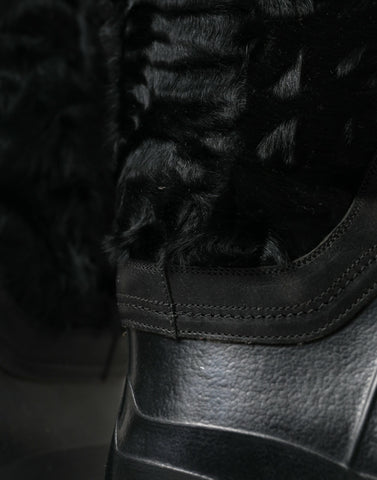 Black rubber lace-up shearling rain boots from Dolce & Gabbana featuring rugged soles and cozy shearling lining.