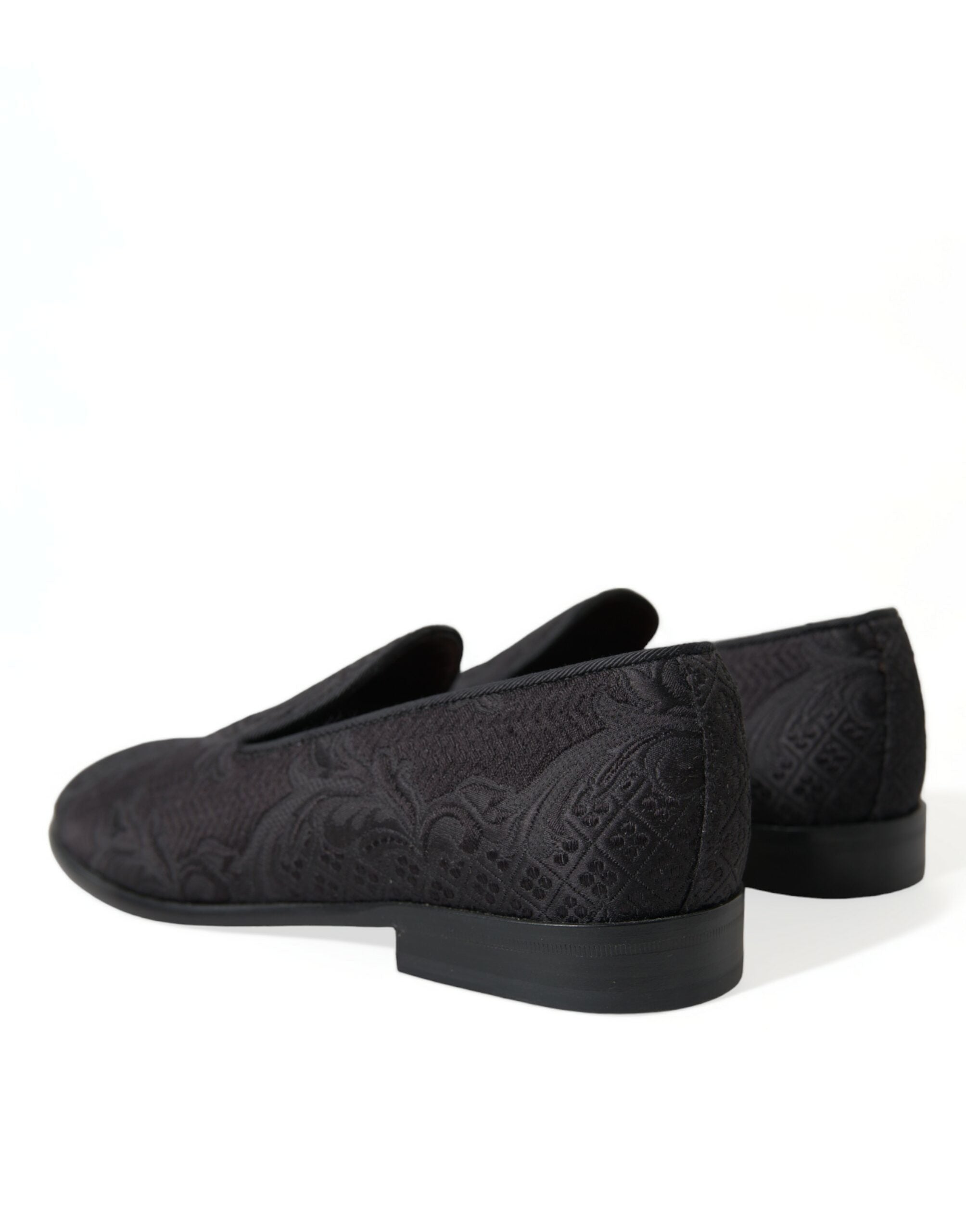 Black brocade men's slip-on loafer dress shoes by Dolce & Gabbana, featuring elegant textured fabric and sleek design.