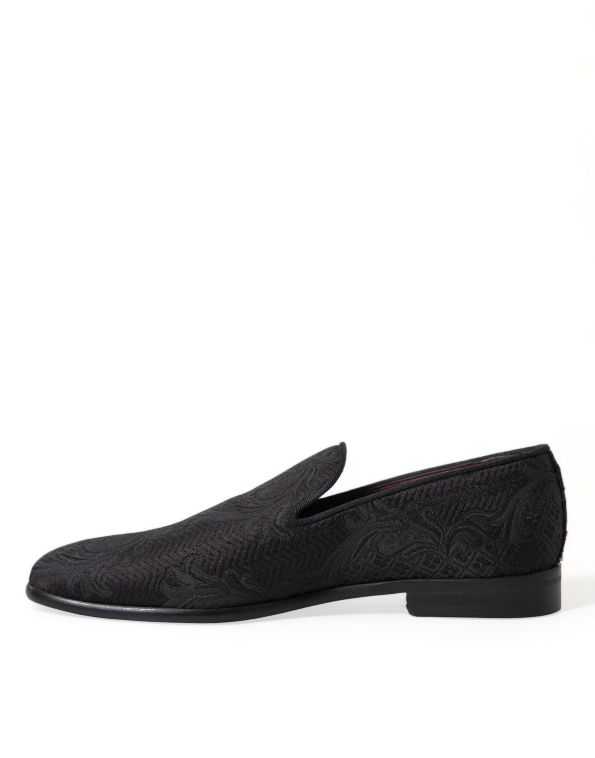 Black brocade slip-on men's dress loafers by Dolce & Gabbana, featuring elegant detailing and a sleek, stylish design.