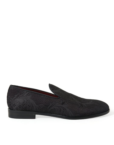 Black brocade men's slip-on loafer dress shoes by Dolce & Gabbana, featuring intricate fabric and sleek design.