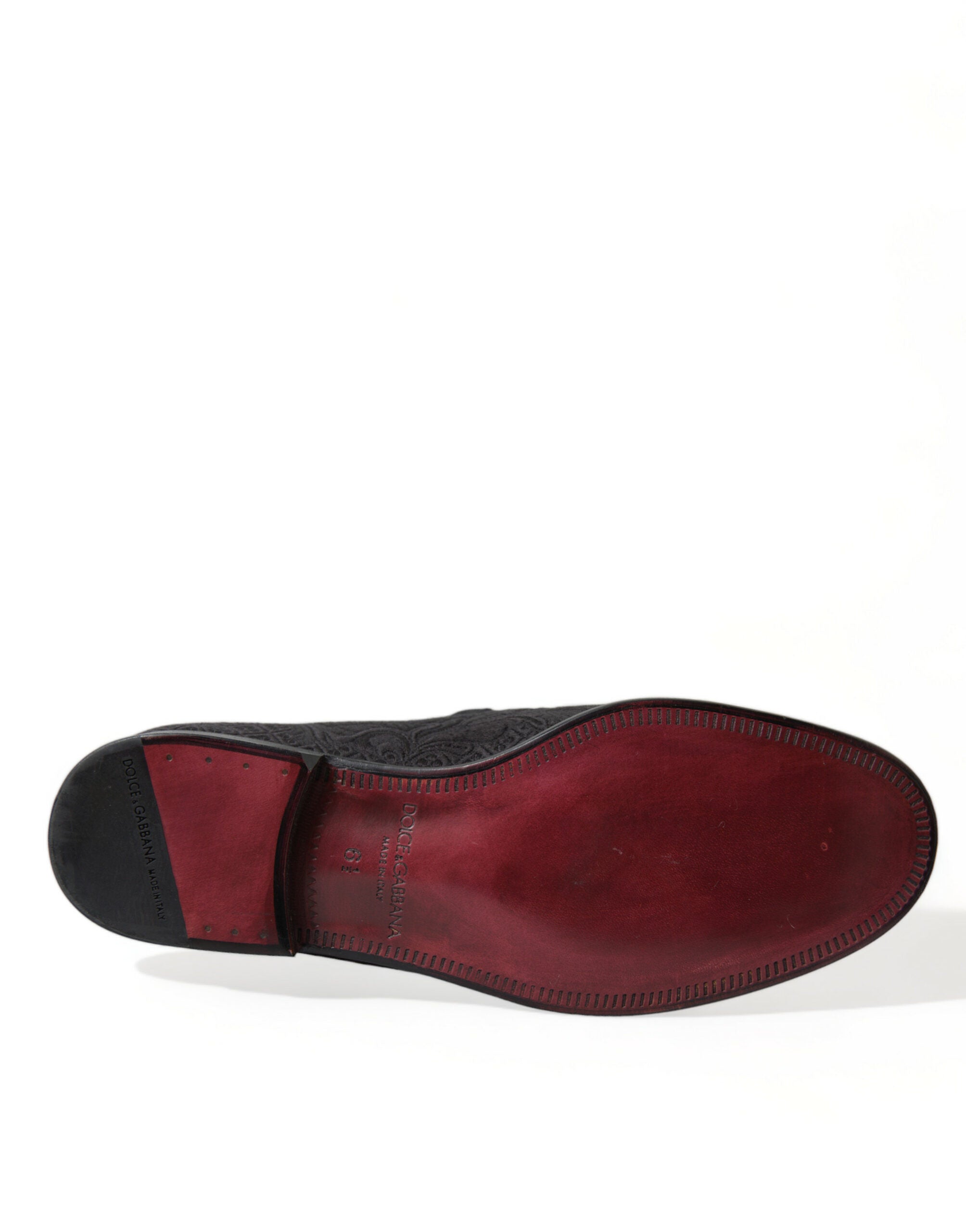 Dolce & Gabbana black brocade slip-on loafer dress shoes for men, stylish and elegant with intricate fabric detail.