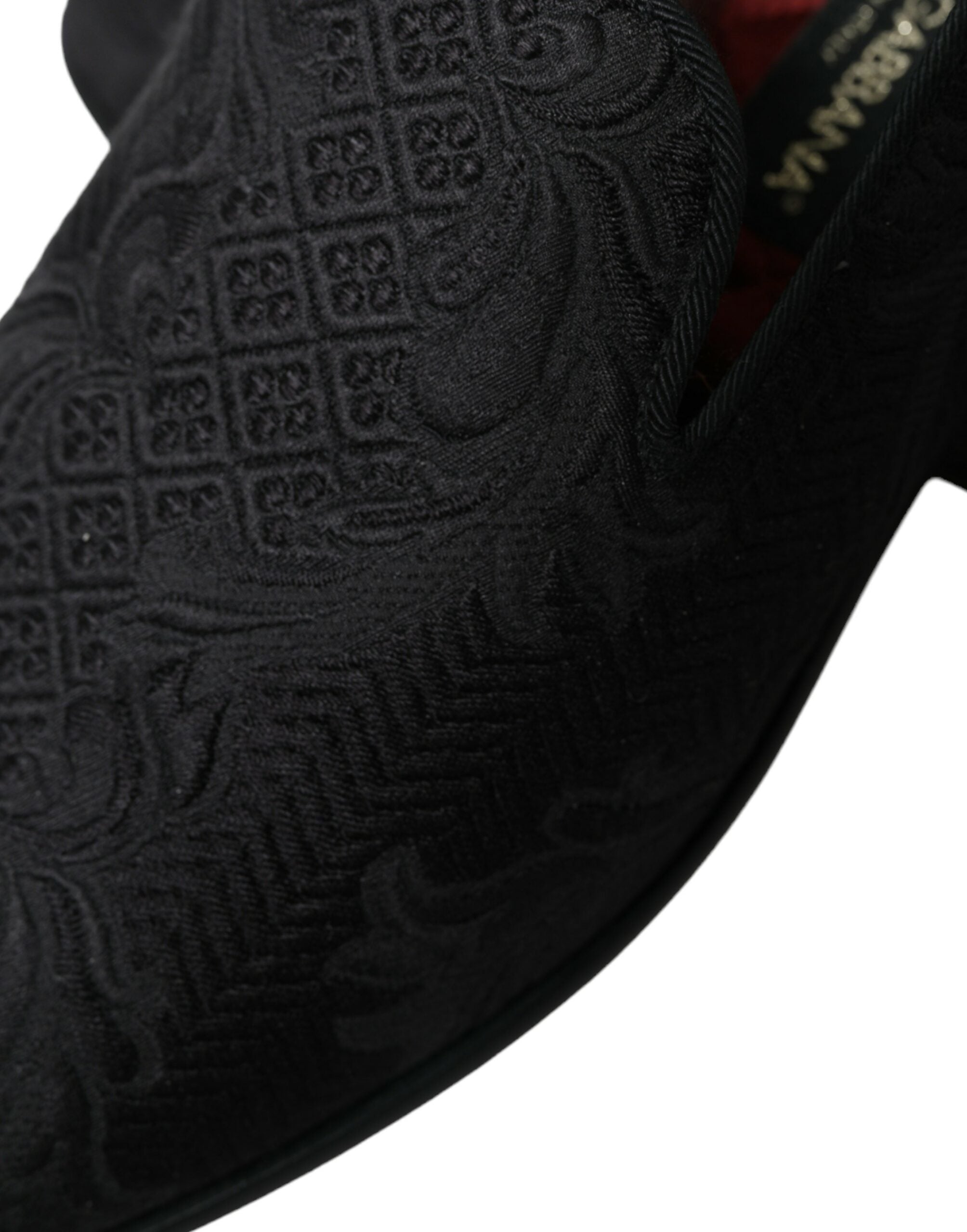 Black brocade men's slip-on loafer dress shoes by Dolce & Gabbana, featuring elegant fabric and classic silhouette.