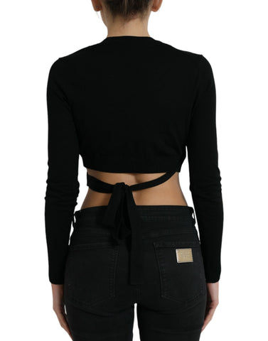 Black wool V-neck cardigan sweater with crossed front design by Dolce & Gabbana, displayed on a neutral background.
