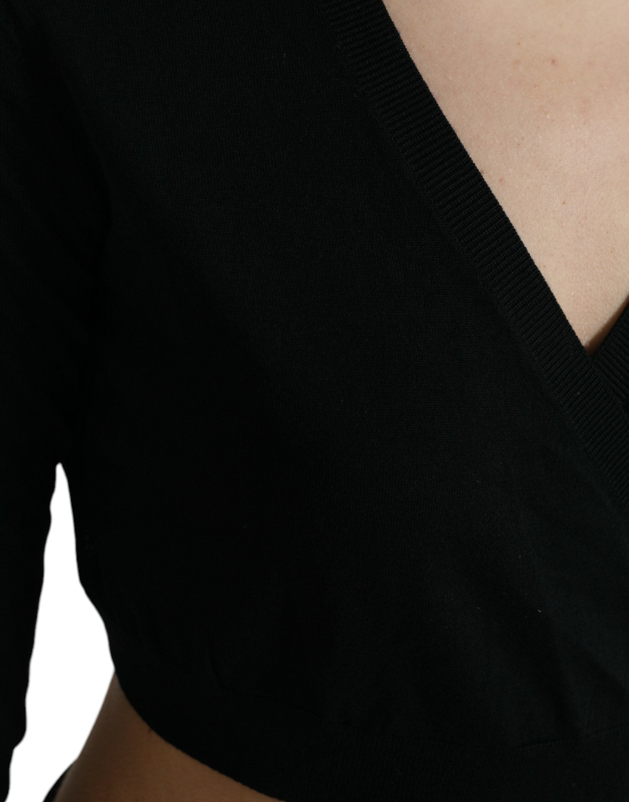 Black wool V-neck crossed cardigan sweater by Dolce & Gabbana, featuring a stylish V-neck design and crossed front detail.