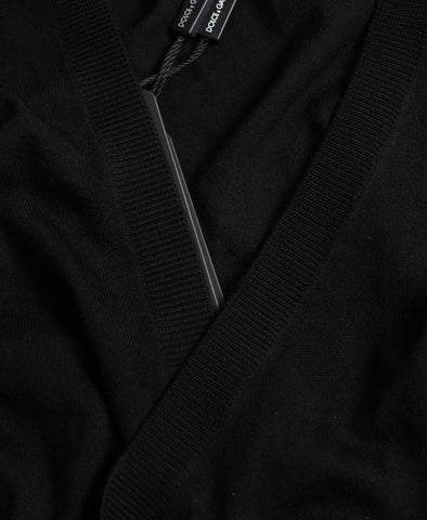 Black wool V-neck crossed cardigan sweater by Dolce & Gabbana displayed on a hanger.