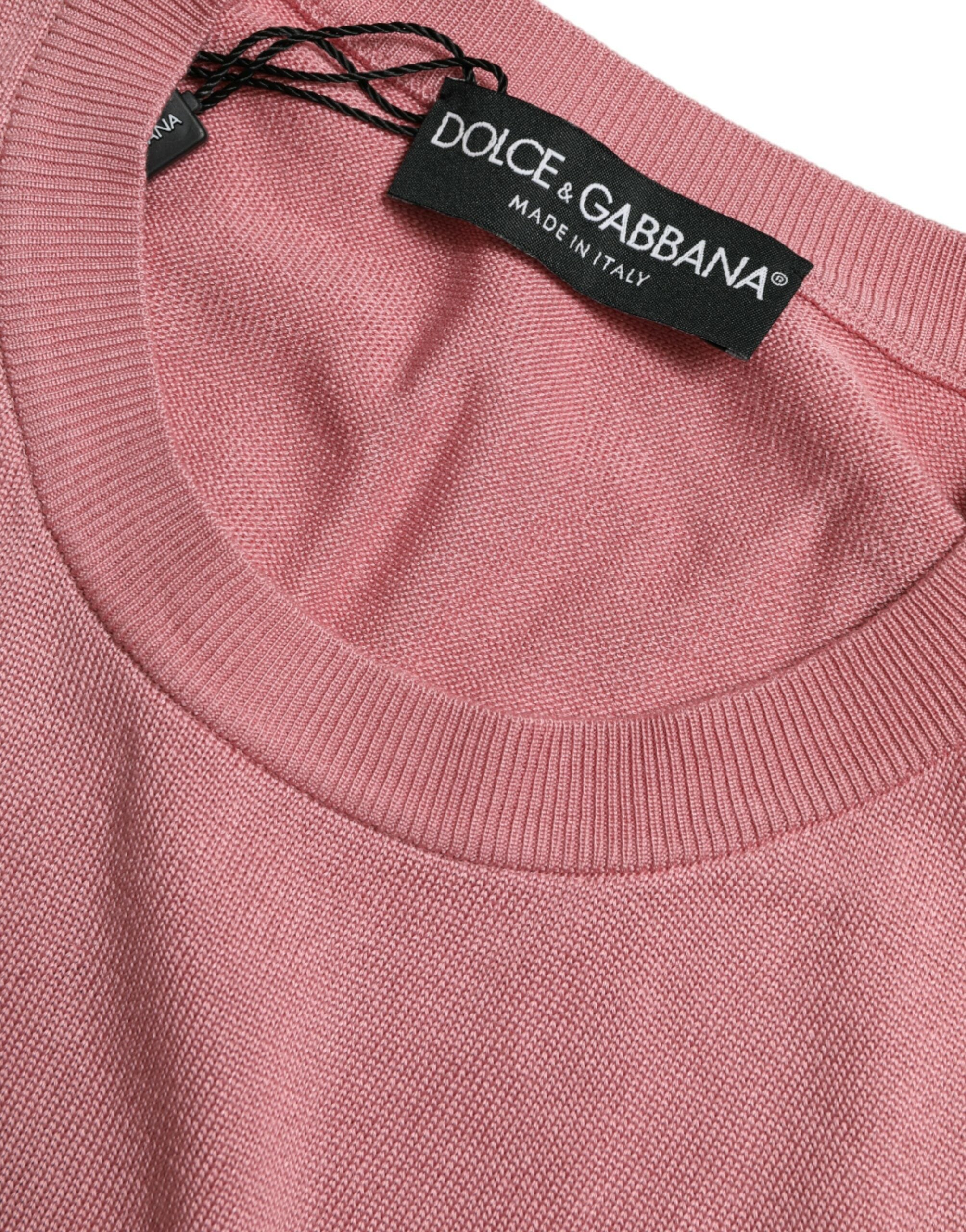 Pink Dolce & Gabbana cropped sleeveless tank top with a crew neck, shown on a hanger against a neutral background.
