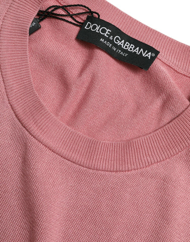 Pink Dolce & Gabbana cropped sleeveless tank top with a crew neck, shown on a hanger against a neutral background.