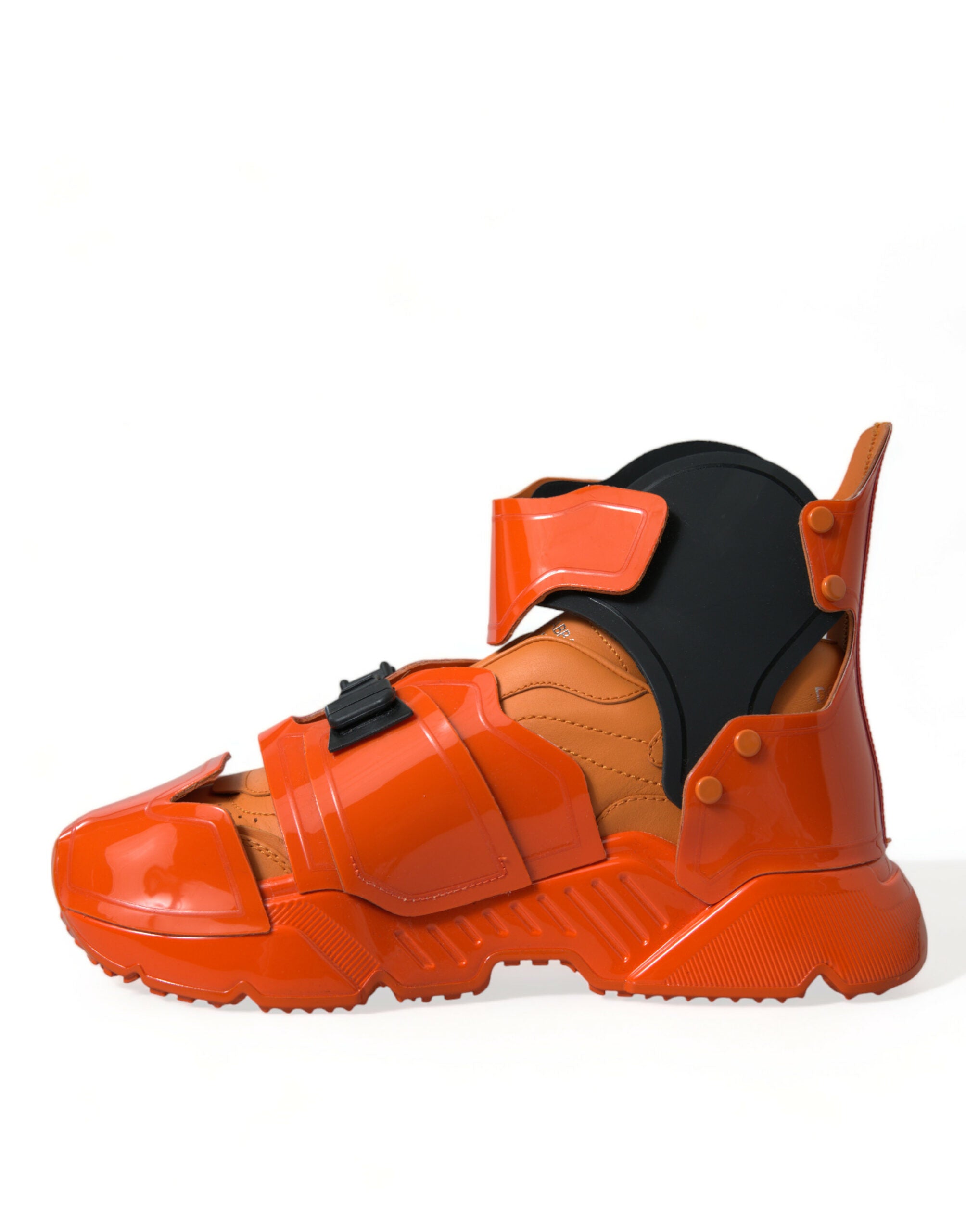 Orange multi-panel chunky high-top sneakers by Dolce & Gabbana with bold design and thick soles, shown from side view.