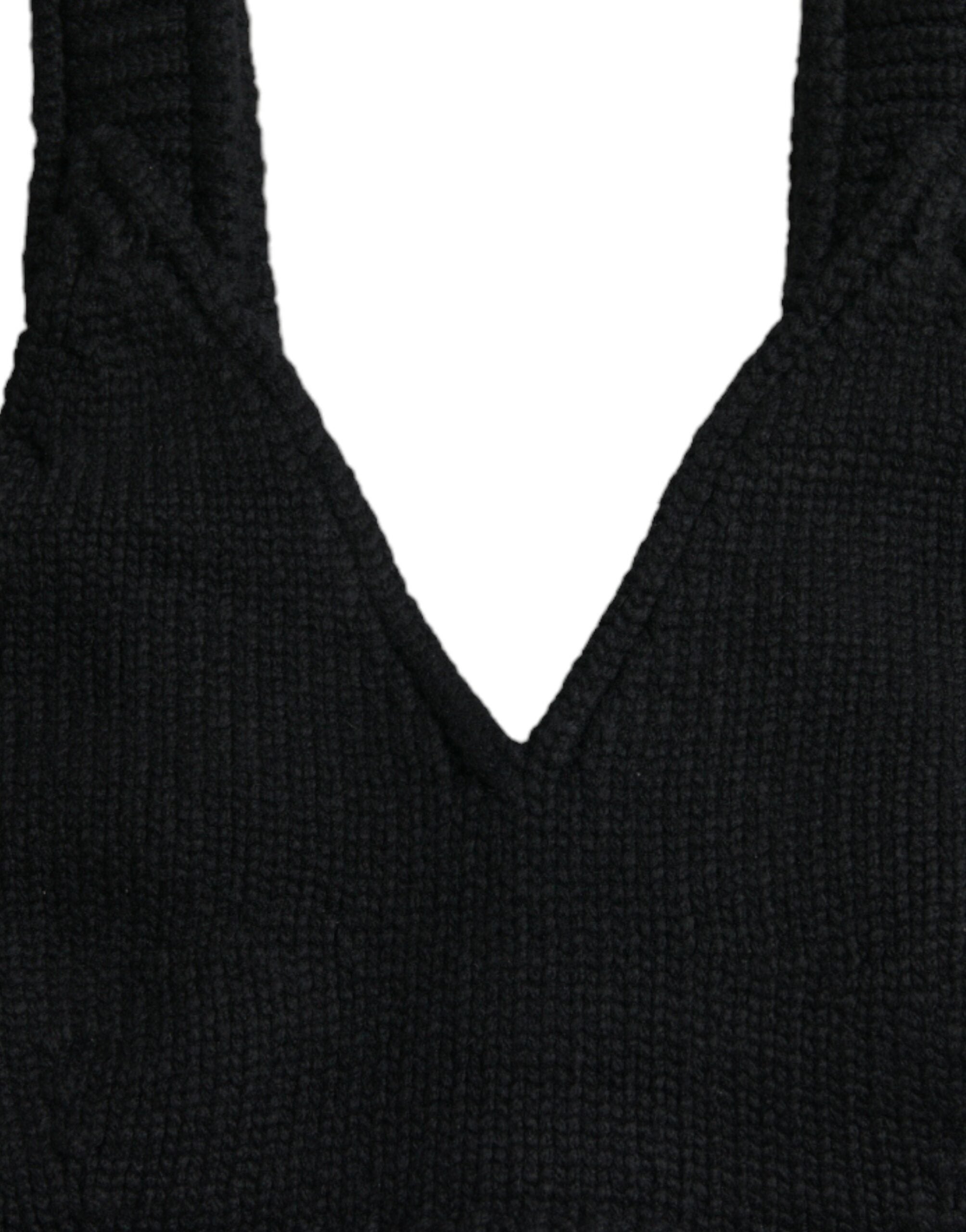 Black cropped cashmere V-neck bustier top by Dolce & Gabbana, shown on a model with close-up of fabric and neckline details.