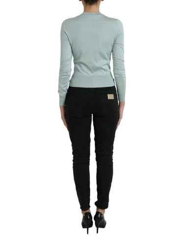 Light blue silk crew neck cardigan sweater by Dolce & Gabbana, displayed on a mannequin.
