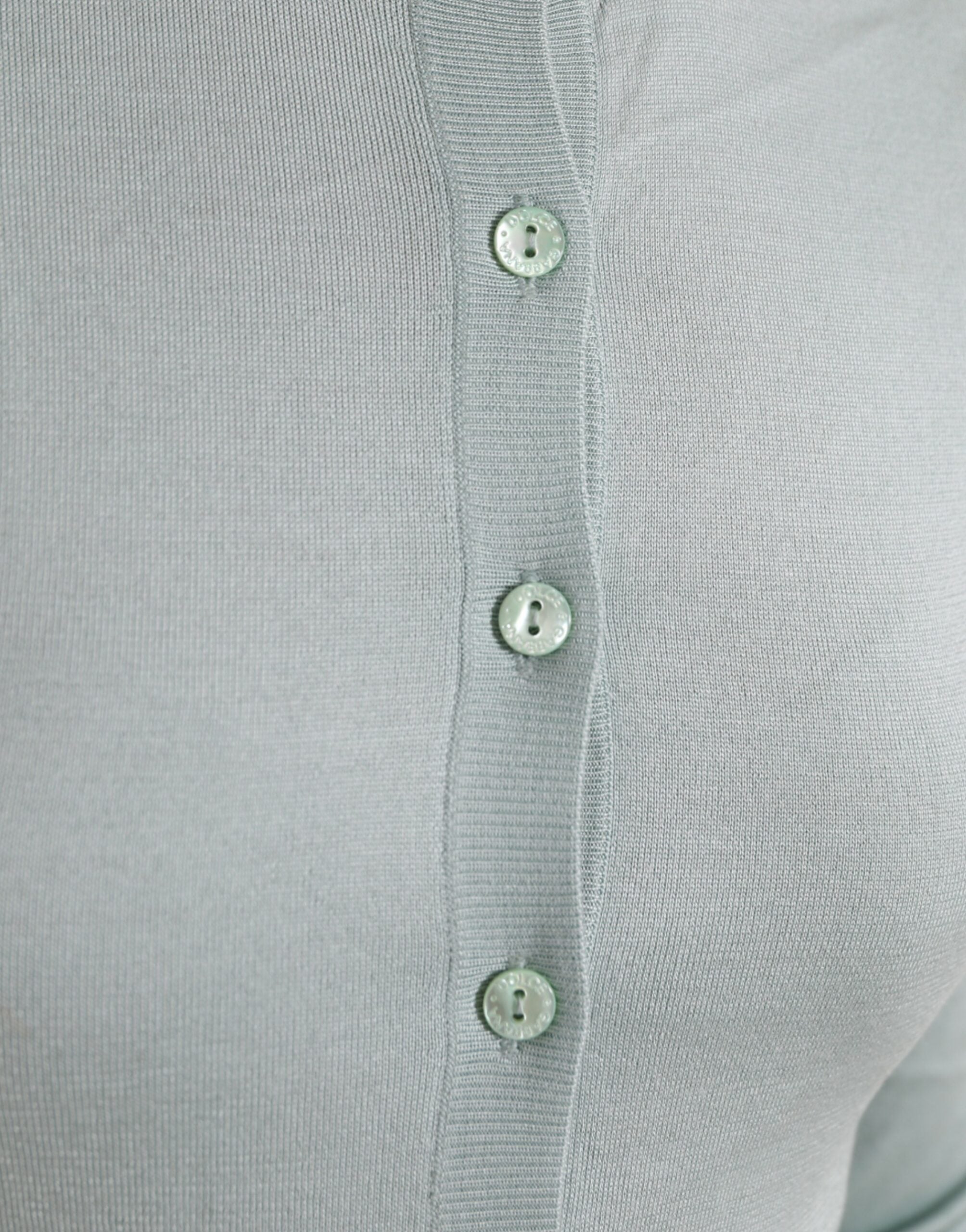 Light blue silk crew neck cardigan sweater by Dolce & Gabbana, showing close-up of soft fabric and classic design.