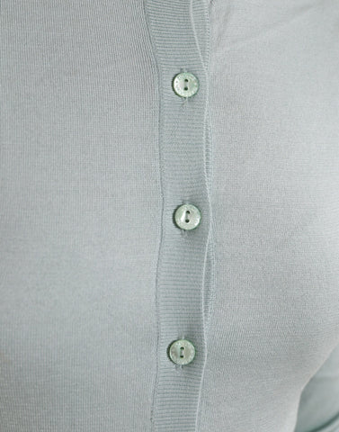 Light blue silk crew neck cardigan sweater by Dolce & Gabbana, showing close-up of soft fabric and classic design.